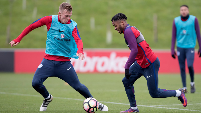 England Under-21s captain James Ward-Prowse challenges Raheem Sterling during training with the senior squad