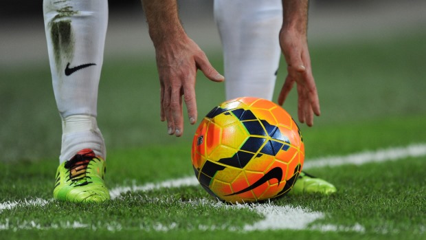 a footballer putting the football in place before kicking 