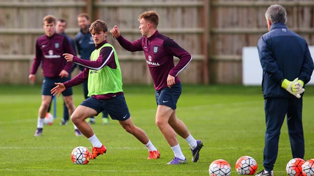 John Swift holds off Solly March during England Under-21s training in Brighton