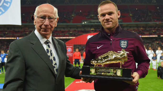 Wayne Rooney collects his golden boot from Sir Bobby Charlton