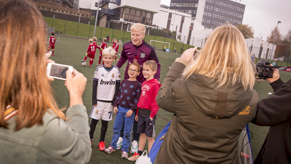 Will Hughes poses with kids at University of Derby
