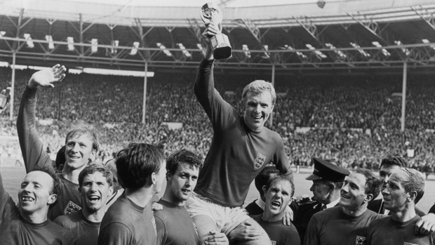 Bobby Moore is held aloft by team mates while raising the World Cup in the air in 1966