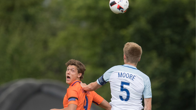 England U19s captain Taylor Moore towers over Dutch striker Sam Lammers to win a header