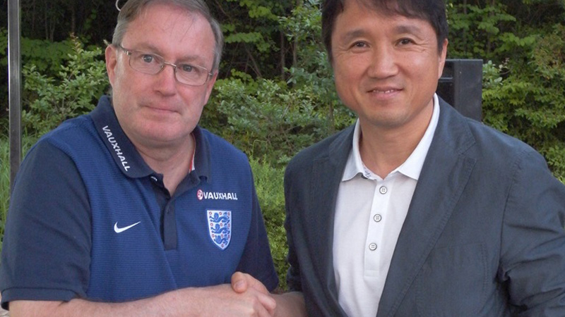 England Under-18s head coach Neil Dewsnip with Kwan Hwang-Bo of the Korean FA.