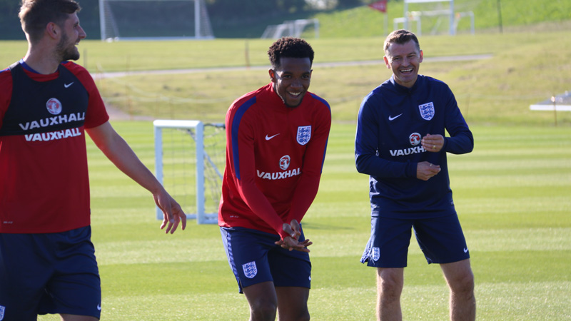 England Under-21s coach Colin Cooper shares a joke with Kasey Palmer and Jack Stephens in training