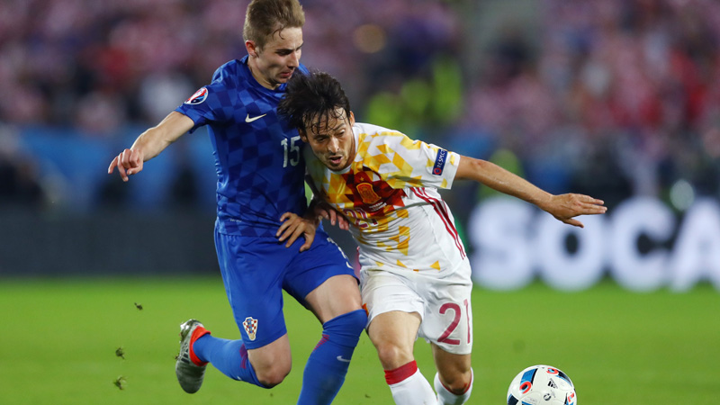 David Silva of Spain and Marko Rog of Croatia compete for the ball in Euro 2016