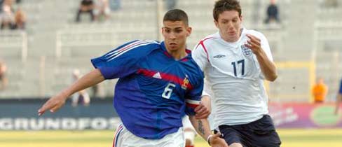 Carl Medjani of France, left, and Greg Halford of England challenge for the ball.