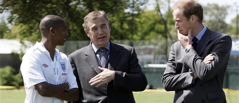 Ashley Young and Sir Trevor Brooking speak to Prince William.