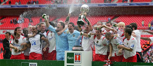 Stevenage players celebrate with The FA Trophy at Wembley.