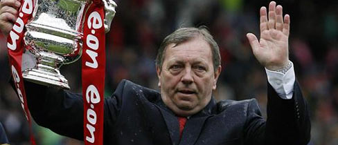 Vic Akers lifts The FA Women's Cup in his final season in charge.