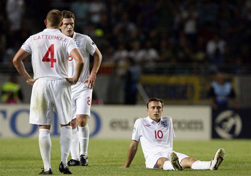 Mark Noble sits dejected on the turf after England's 4-0 defeat in the Final of the European Championship.