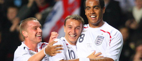Mark Noble and Jamie O'Hara congratulate Tom Huddlestone on his goal against Wales at Villa Park.