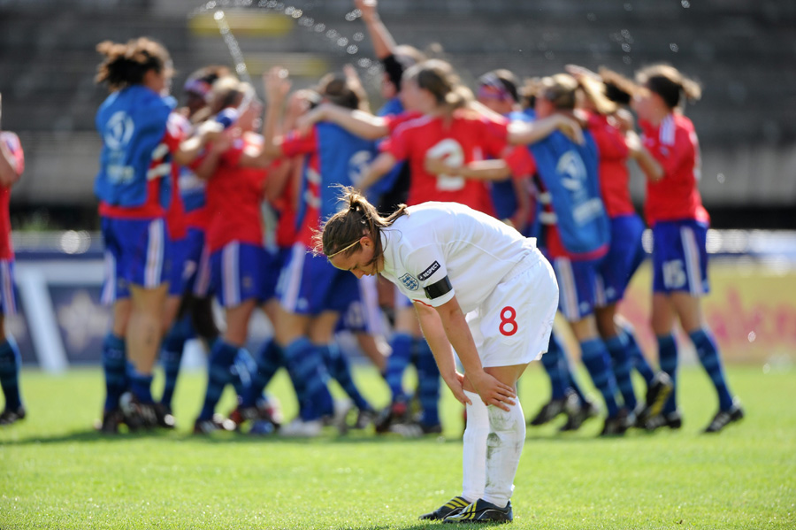 Jordan Nobbs stands dejected as France celebrate Final victory