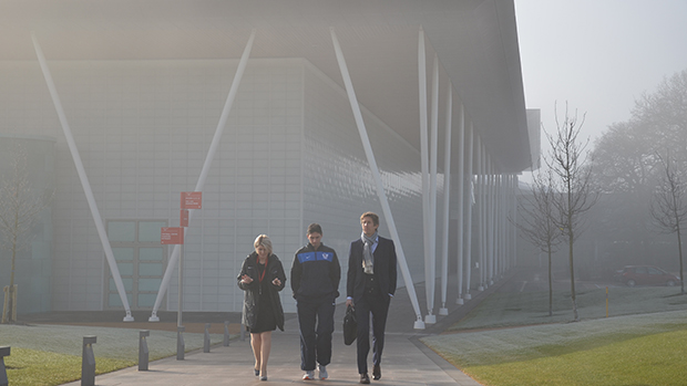 Edwin van der Sar walks from a cloud covered football centre to the hotels