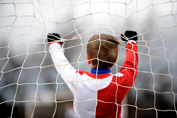 Boy holding goal net