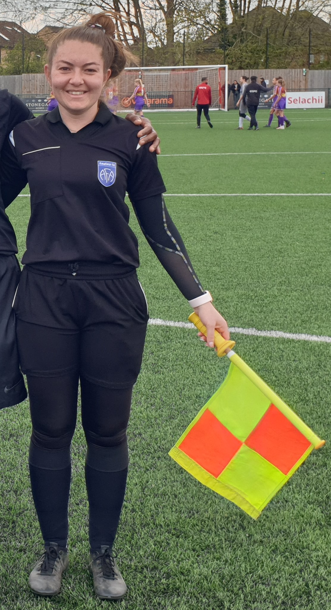 Olivia Brownlee holding her assistant referee flag