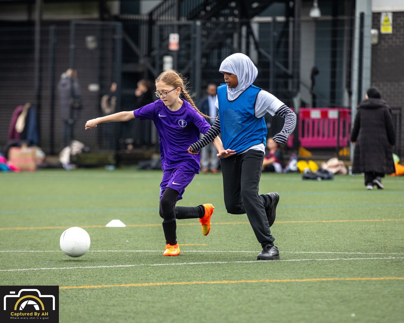 Two girls playing football