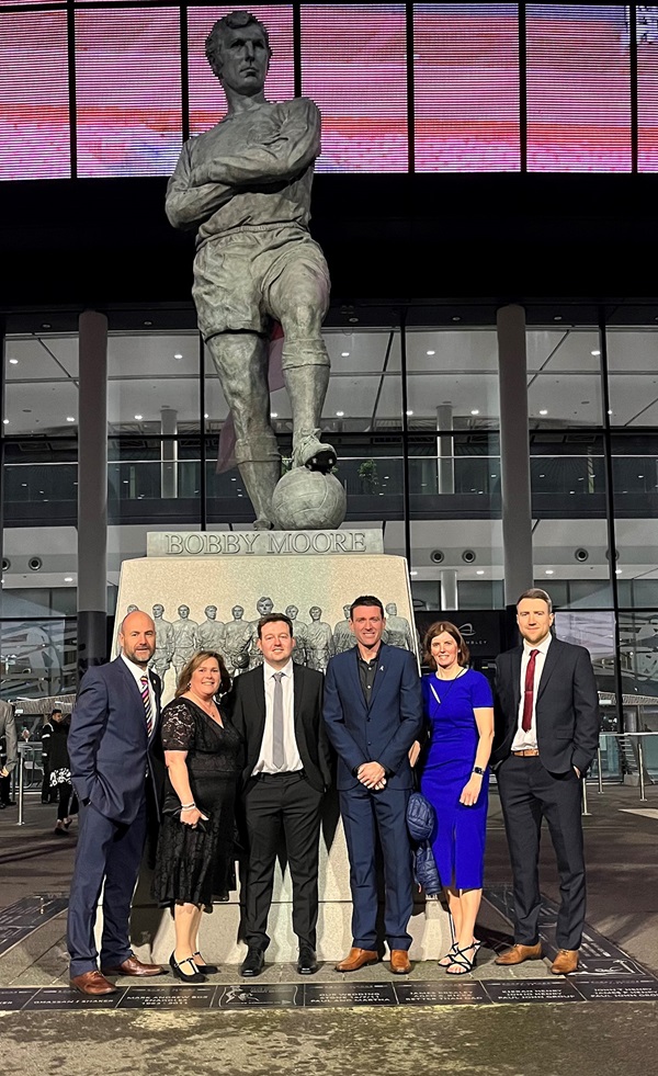 Cumberland FA staff pose with Bobby Moore statue