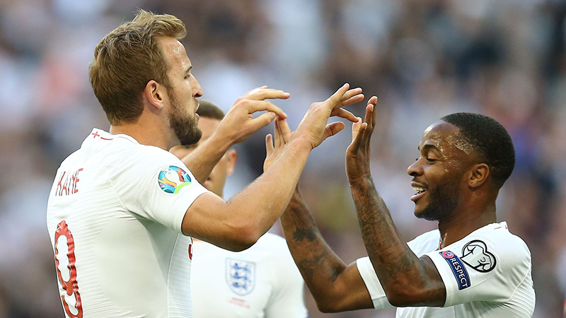 Harry Kane celebrates scoring the opening goal with team-mate Raheem Sterling