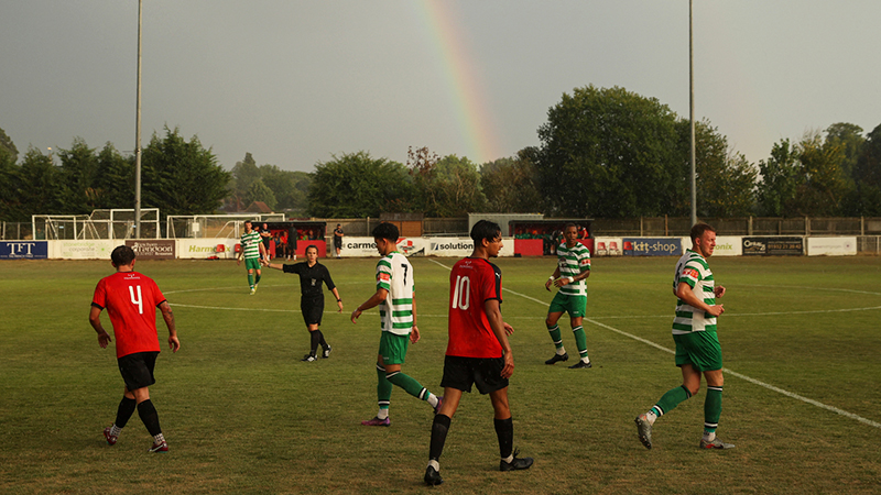 Rainbow backdrop on pitch