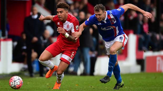Harry Osborne of Welling United (L) battles for the ball with Charlie Wyke of Carlisle United