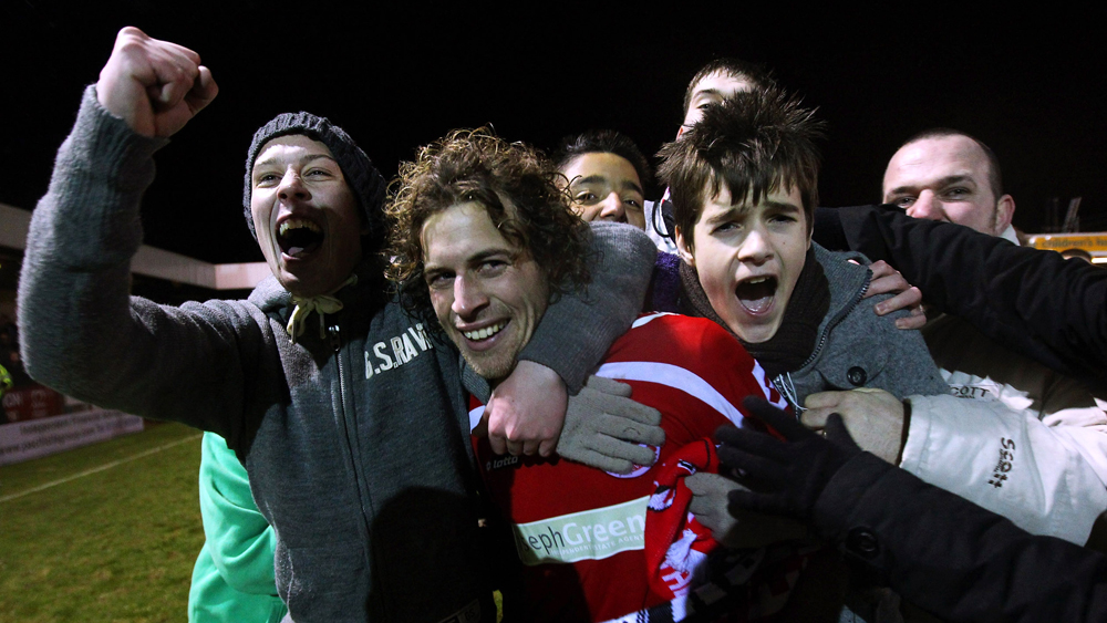 Crawley fans mob Sergio Torres after they defeated Torquay United in 2011