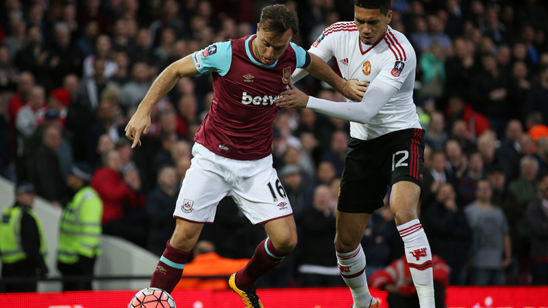 West Ham captain Mark Noble holds off a challenge from Chris Smalling