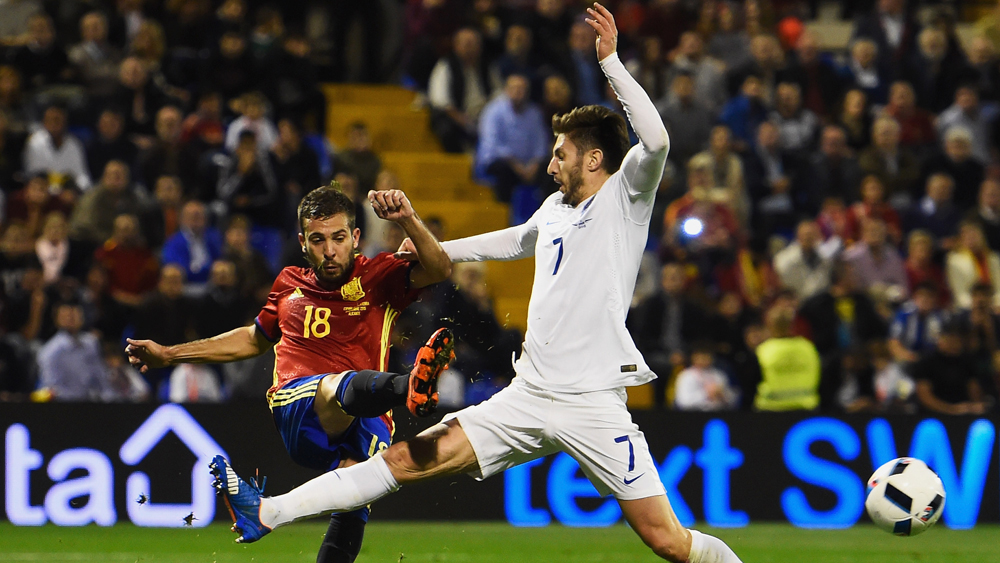Jordi Alba tussles with Adam Lallana