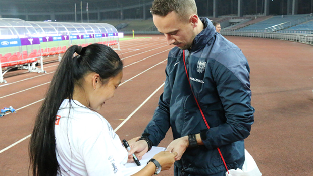 England head coach Mark Sampson signs an autograph for a Chinese fan