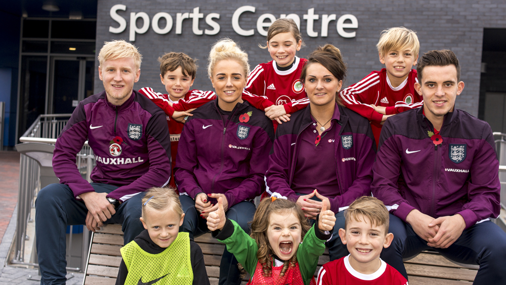 Will Hughes, Alex Greenwood, Melissa Lawley and Jamie Hanson with kids at University of Derby