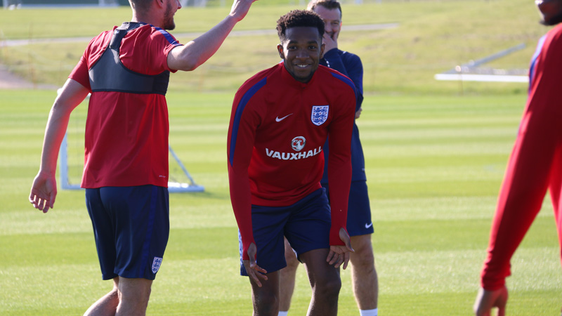Kasey Palmer shares a joke with his England Under-21s team-mates in training