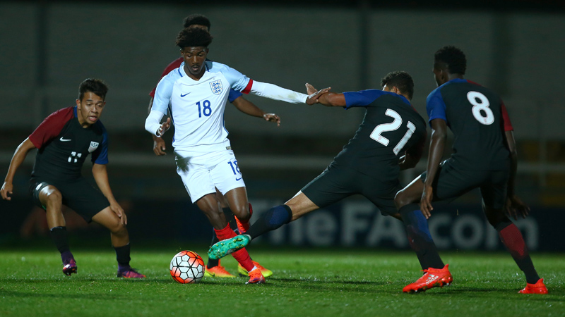 England U20s captain Ainsley Maitland-Niles evades the challenge of three USA defenders.